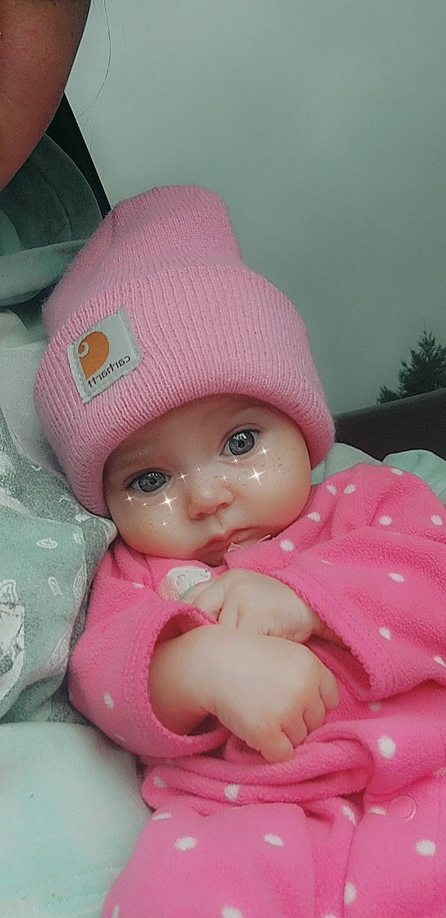 Riverlynn joined the competition — help win amazing prizes! baby, baby_toddler_clothing, beanie, cap, cheek, child, costume_hat, doll, dress, fashion_accessory, fedora, hat, headwear, knit_cap, magenta, peach, person, pink, sun_hat, toy