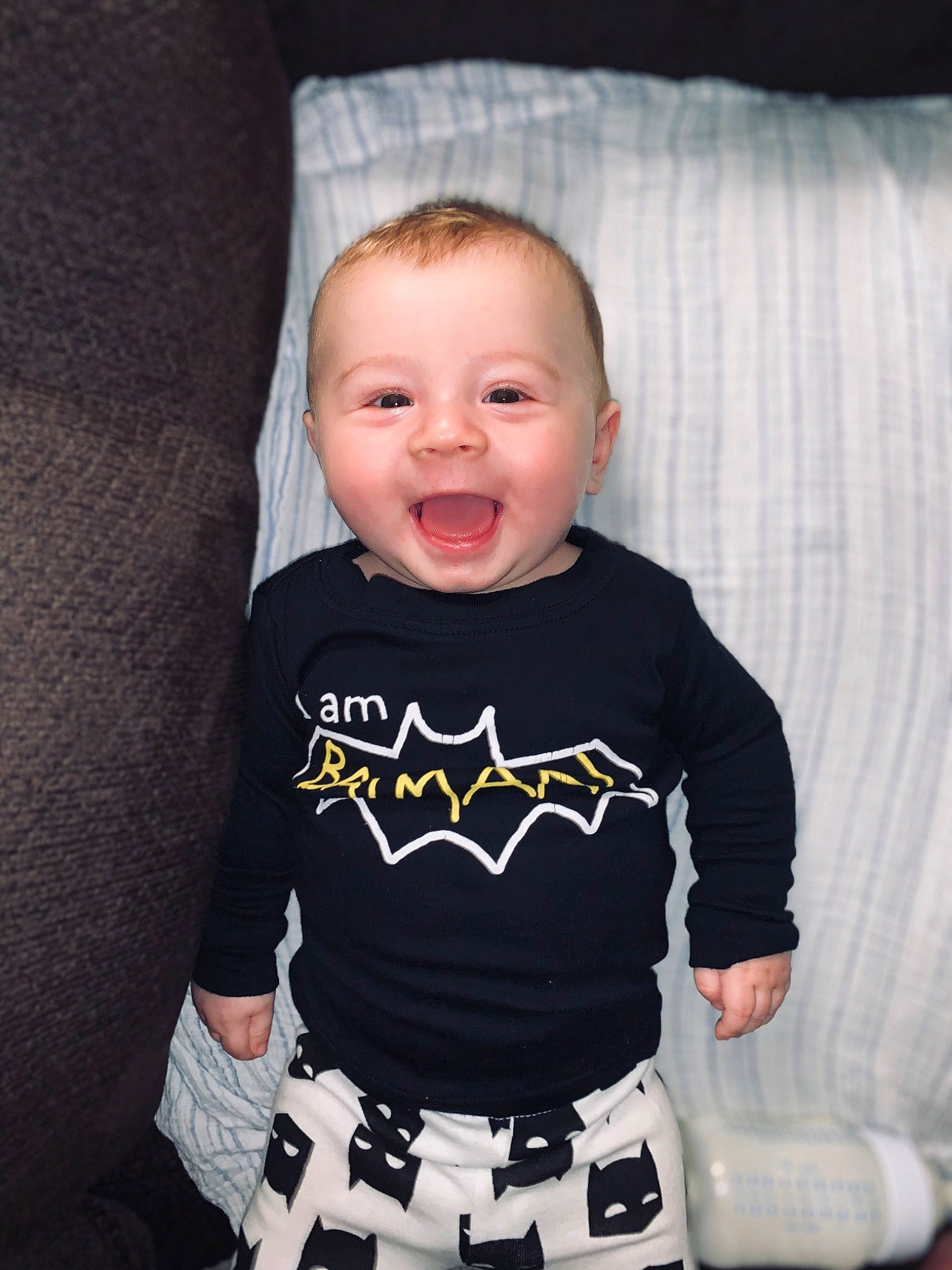 Byron is registered to the contest to win money with this photo: baby, baby_products, baby_toddler_clothing, batman, cheek, child, cool, face, fictional_character, head, outerwear, person, photography, product, skin, sleeve, smile, t_shirt, toddler