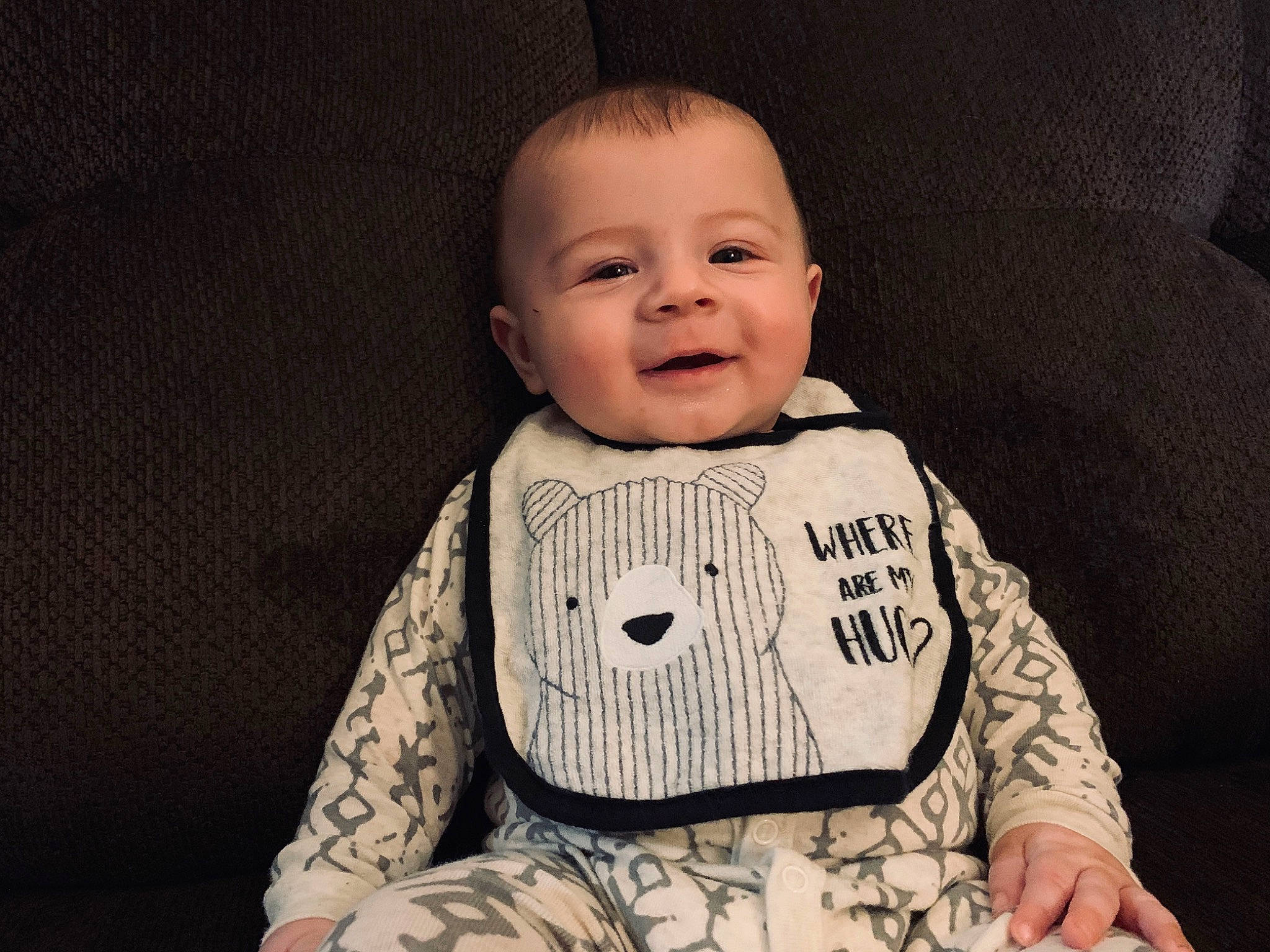 Byron is registered to the contest to win money with this photo: baby, baby_toddler_clothing, cheek, child, face, facial_expression, head, nose, outerwear, person, photography, portrait, portrait_photography, product, sitting, sleeve, smile, toddler
