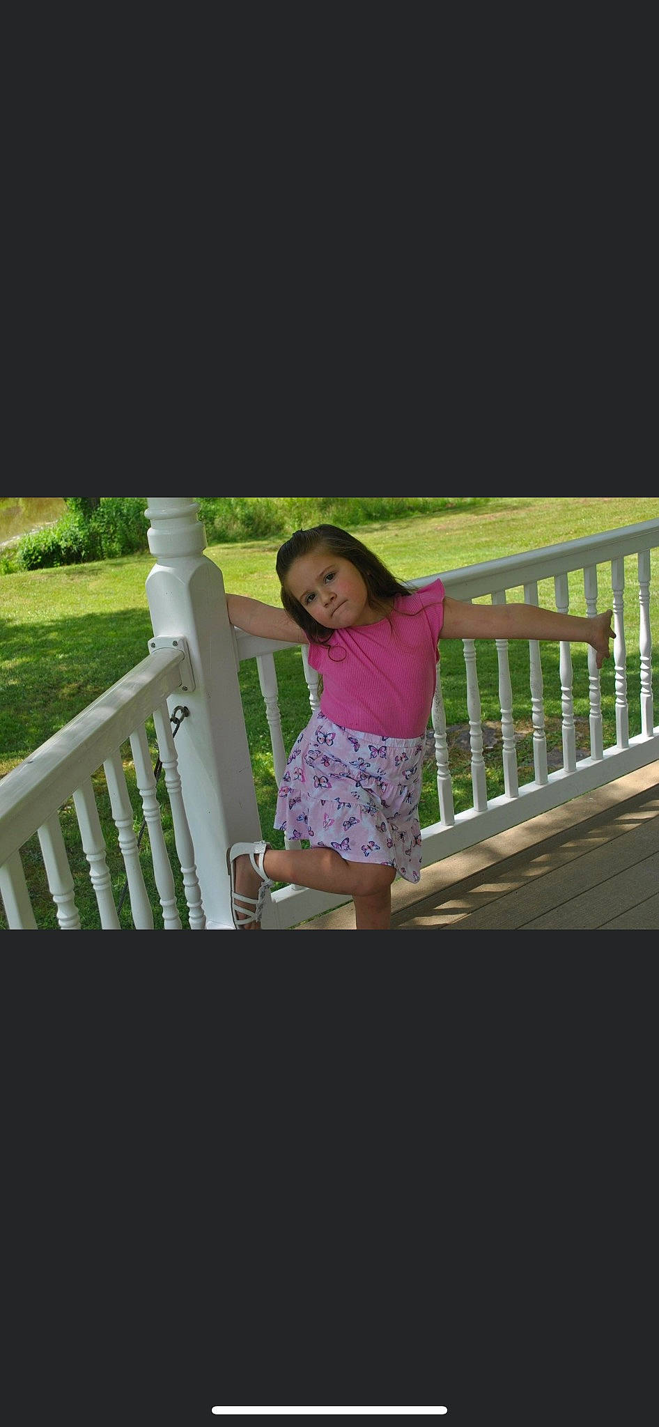 Haley joined the competition — help win amazing prizes! child, fence, flash_photography, fun, grass, handrail, happy, human_leg, leisure, magenta, pattern, person, plant, recreation, shorts, sitting, sleeve, t_shirt, toddler, tree