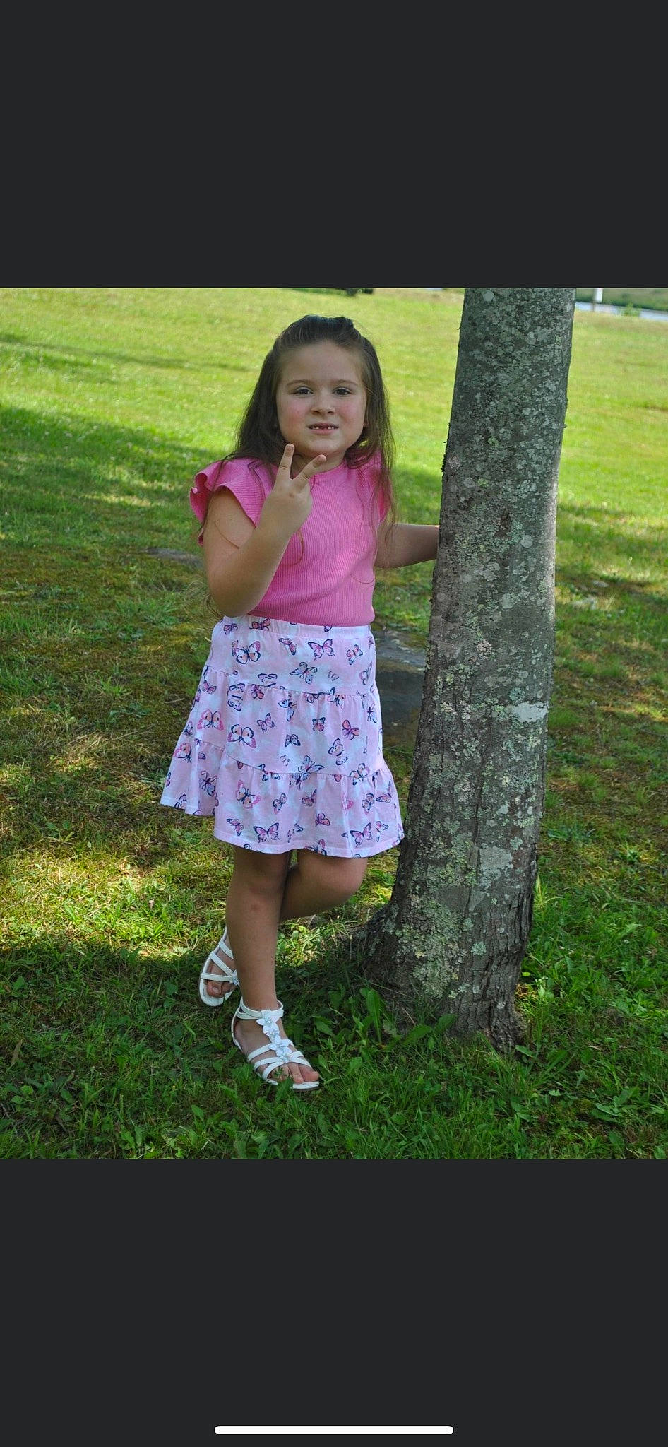 Haley is registered to the contest to win money with this photo: baby_toddler_clothing, child, fun, grass, grass_family, happy, human_leg, lawn, leisure, magenta, pattern, people_in_nature, person, pink, plant, smile, spring, toddler, tree, trunk