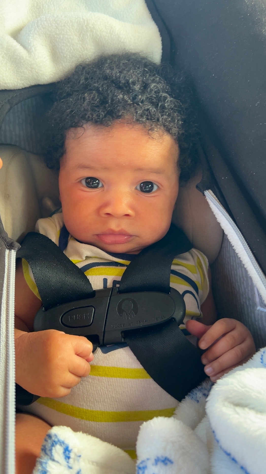 Yahson Mayberry joined the competition — help win amazing prizes! baby, infant, car_seat, harness, blanket, curly_hair, cute, child, portrait, closeup, straps, clothing, hand, face, seat, safety, expression, indoor, person, young