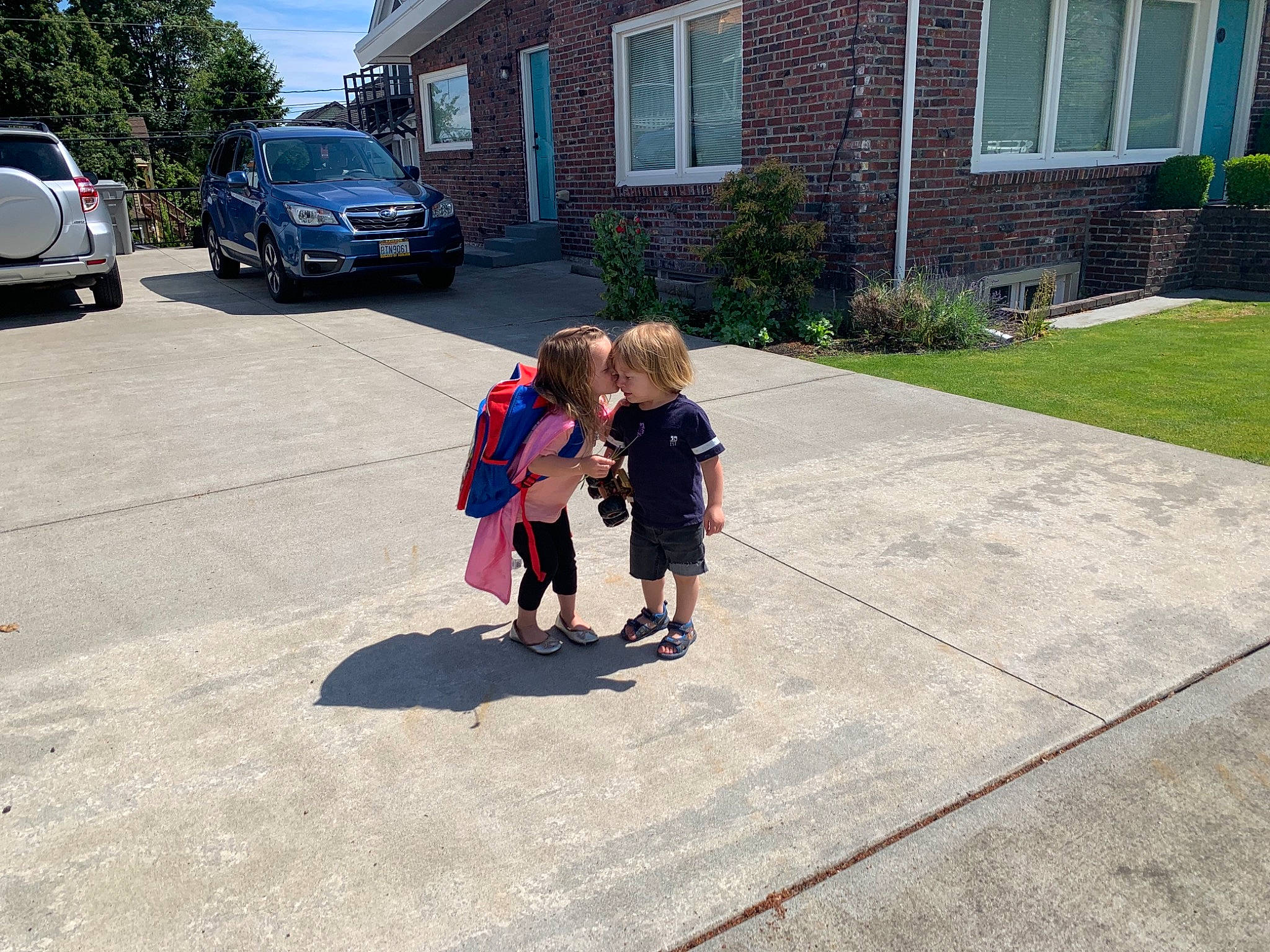 Lyra joined the competition — help win amazing prizes! asphalt, car, driveway, flooring, grass, house, landscape, leisure, neighbourhood, person, plant, public_space, recreation, road_surface, sidewalk, tire, toddler, tree, vehicle_registration_plate, wheel