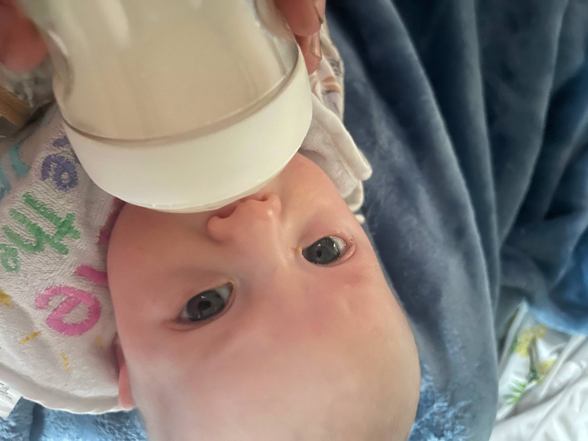 Olive is registered to the contest to win money with this photo: baby, cap, cheek, child, chin, close_up, drinkware, eye, eyebrow, eyelash, hat, head, headgear, helmet, lip, mouth, neck, nose, person, skin