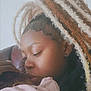 affection, baby, braids, caring, child, close_up, curly_hair, earring, family, hair, holding, indoor, kiss, love, pink_blanket, portrait, skin, soft_lighting, tender_moment, woman