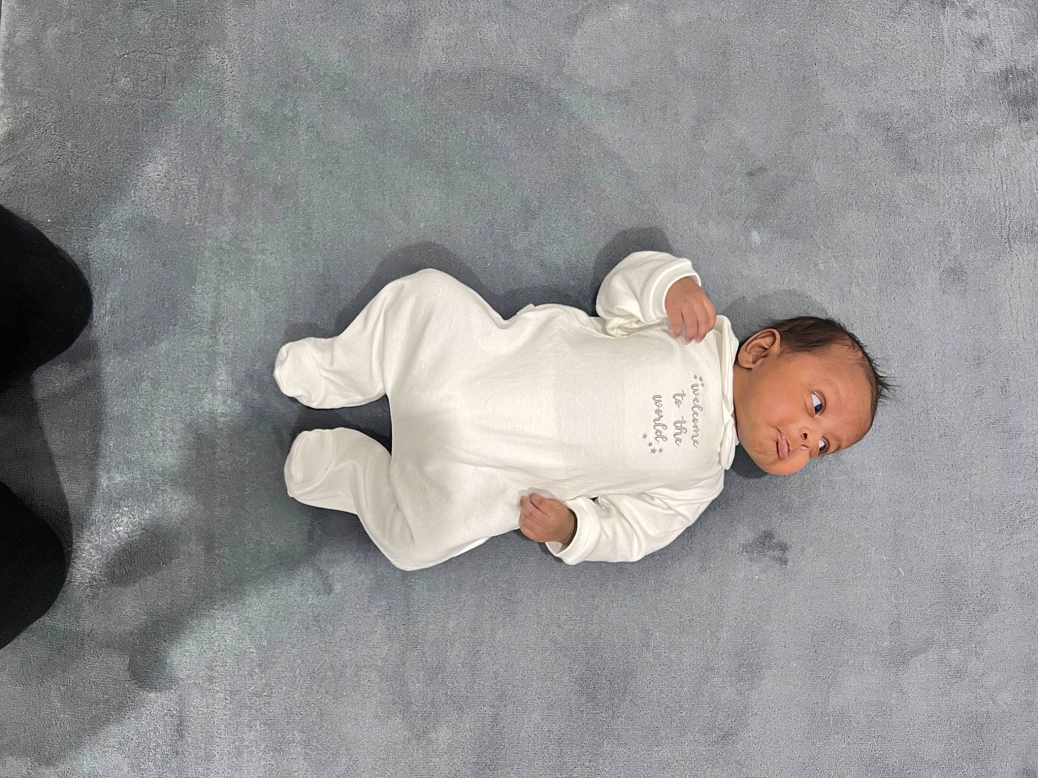 Jayvion is registered to the contest to win money with this photo: baby, baby_products, baby_sleeping, baby_toddler_clothing, child, comfort, elbow, flooring, font, person, sitting, sleep, sleeve, sock, t_shirt, toddler