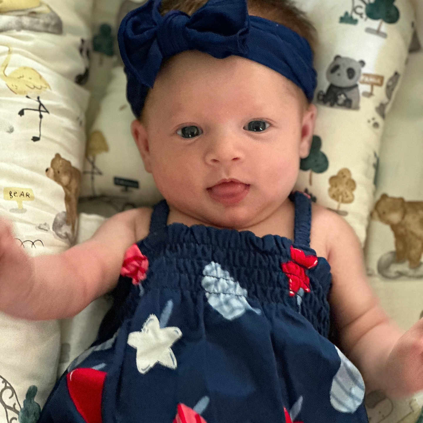 Charleigh joined the competition — help win amazing prizes! animal_print, baby, background, bear, blue_dress, child, cushion, cute, dress, headband, indoors, infant, lying_down, panda, playful, popsicle, smiling, stars, tongue_out, young_child