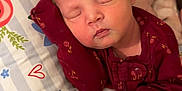 Charleigh joined the competition — help win amazing prizes! baby, bedroom, child, closed_eyes, cozy, cute, face, floral_pattern, hand, indoor, infant, maroon_clothing, newborn, peaceful, person, pillow, resting, sleeping, soft_lighting, young