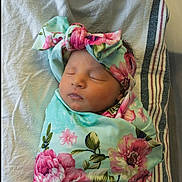 Charleigh joined the competition — help win amazing prizes! newborn, baby, sleeping, swaddled, blanket, headband, floral, flower_pattern, infant, peaceful, cute, soft, bed, striped, white, wrapped, portrait, child, resting, cozy