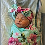 newborn, baby, sleeping, swaddled, blanket, headband, floral, flower_pattern, infant, peaceful, cute, soft, bed, striped, white, wrapped, portrait, child, resting, cozy