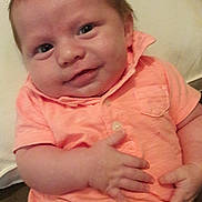 Greyson is registered to the contest to win money with this photo: baby, infant, smiling, face, hair, clothing, shirt, pants, hand, cushion, indoor, person, child, young, cute, portrait, skin, expression, happy, closeup