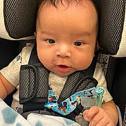 Felix joined the competition — help win amazing prizes! baby, infant, car_seat, pacifier, blanket, child, cute, straps, clothing, hand, face, head, indoors, sitting, safety, young_child, portrait, expression, comfort, closeup