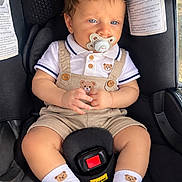 Jalmer joined the competition — help win amazing prizes! baby, infant, child, car_seat, pacifier, sitting, portrait, indoors, vehicle, seatbelt, toddler, smiling, blue_eyes, brown_hair, overalls, shoes, socks, teddy_bear, close_up, photography