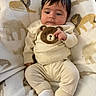 baby, infant, child, blanket, bear, animal_print, clothing, cute, cozy, soft, smile, face, sitting, indoors, portrait, comfort, warm, white_socks, hair, toddler
