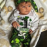 baby, child, infant, clothing, hat, green, shamrock, st_patricks_day, blanket, white_shirt, pants, sitting, cute, portrait, indoors, face, person, soft_texture, holiday, celebration