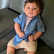 Mateo joined the competition — help win amazing prizes! baby, beige_shorts, blue_shirt, boy, casual_clothing, child, comfortable, couch, curly_hair, cute, expression, furniture, home, indoors, leather, portrait, sitting, striped_shirt, white_socks, young_child