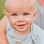 Alistir is registered to the contest to win money with this photo: baby, child, smiling, blue_eyes, blond_hair, toddler, close_up, portrait, outdoor, person, cute, happy, infant, clothing, shirt, hand, adult, face, skin, background