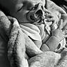 baby, sleeping, pacifier, blanket, infant, hand, monochrome, soft_texture, cute, peaceful, portrait, young_child, resting, closeup, indoors, cozy, wrapped, newborn, face, child