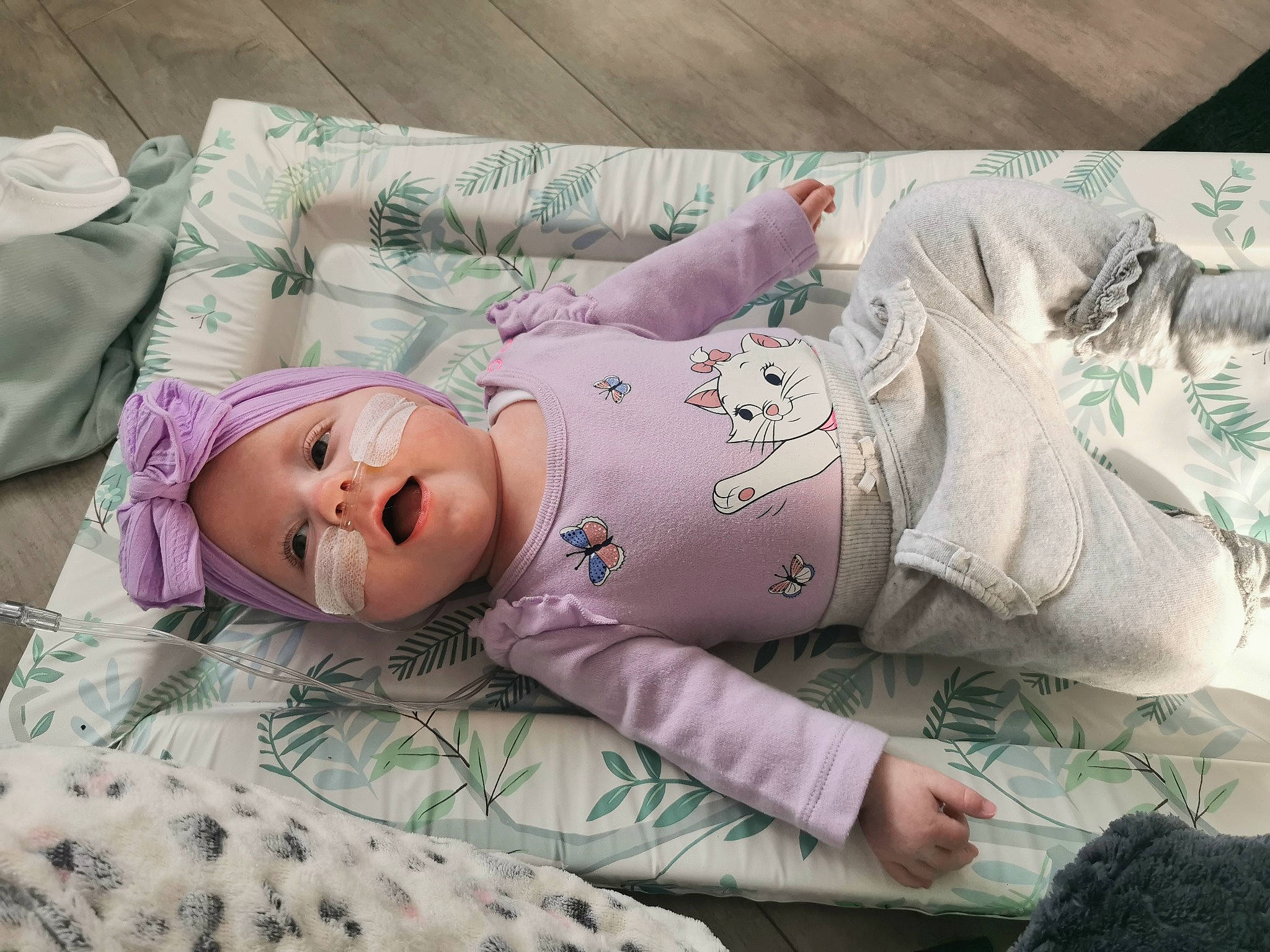 Holly joined the competition — help win amazing prizes! baby, baby_toddler_clothing, bedding, bedtime, child, comfort, eye, facial_expression, grass, hat, headwear, human_body, linens, person, pink, purple, skin, sleeve, t_shirt, textile