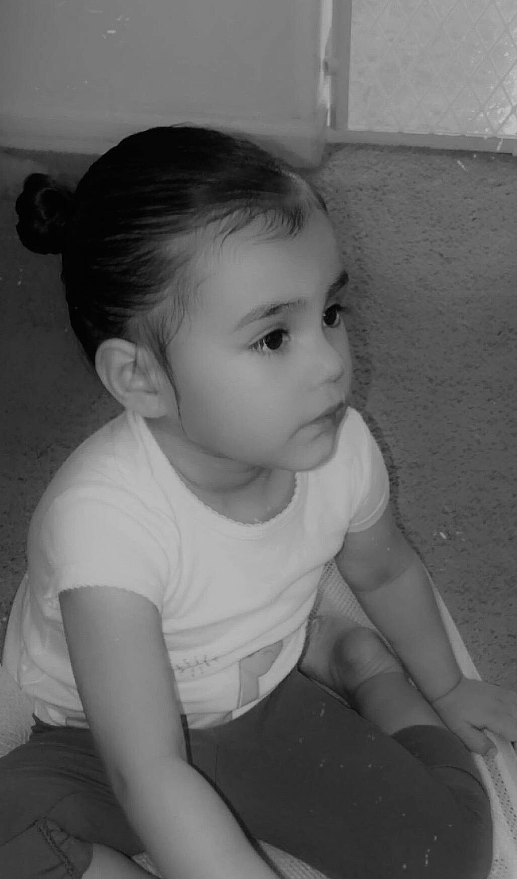 Carmen is registered to the contest to win money with this photo: baby, black, cheek, child, ear, elbow, eyebrow, eyelash, flash_photography, happy, iris, monochrome, monochrome_photography, neck, person, sitting, skin, smile, t_shirt, toddler