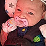 Madison joined the competition — help win amazing prizes! baby, infant, child, car_seat, pacifier, headband, bow, harness, seatbelt, portrait, close_up, lying_down, sleepy, face, eyes, clothing, stars, pink, blue, indoors