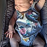 baby, infant, sleeping, child, portrait, floral_clothing, romper, socks, padded_seat, baby_seat, seated, raised_arm, hands, face, hair, indoors, close_up, adorable, nap, photography