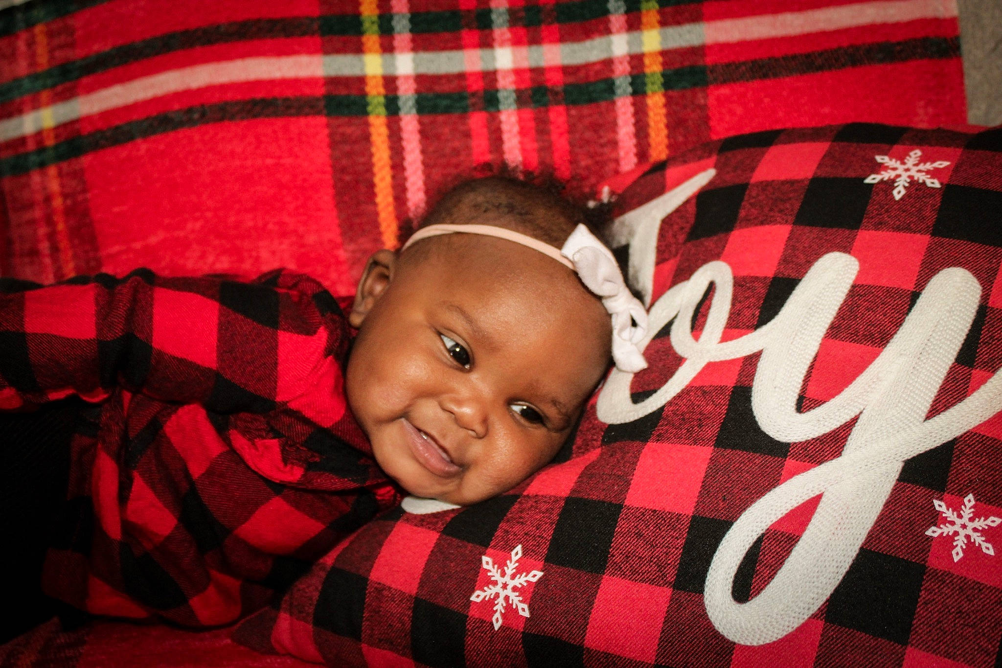 Kamryn joined the competition — help win amazing prizes! baby, baby_toddler_clothing, cheek, child, comfort, design, event, flash_photography, flooring, happy, orange, pattern, person, plaid, red, sleeve, smile, tartan, textile, toddler
