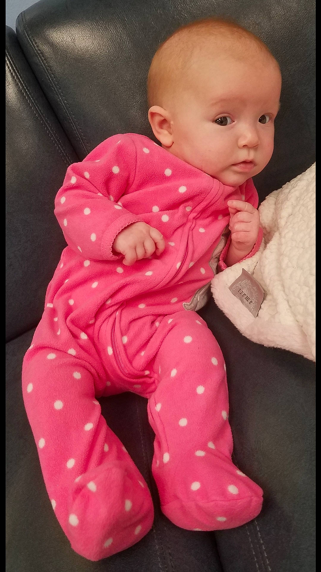 Cass is registered to the contest to win money with this photo: baby, baby_toddler_clothing, cheek, child, design, lip, pajamas, pattern, person, pink, sitting, skin, toddler