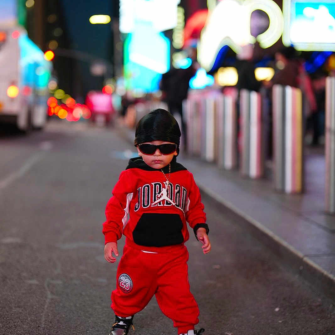 Arian Ovalle joined the competition — help win amazing prizes! casual, child, city, cool, durag, fashion, jordan, lights, neon, night, outdoor, portrait, red_clothing, sidewalk, sneakers, street, sunglasses, toddler, urban, walking