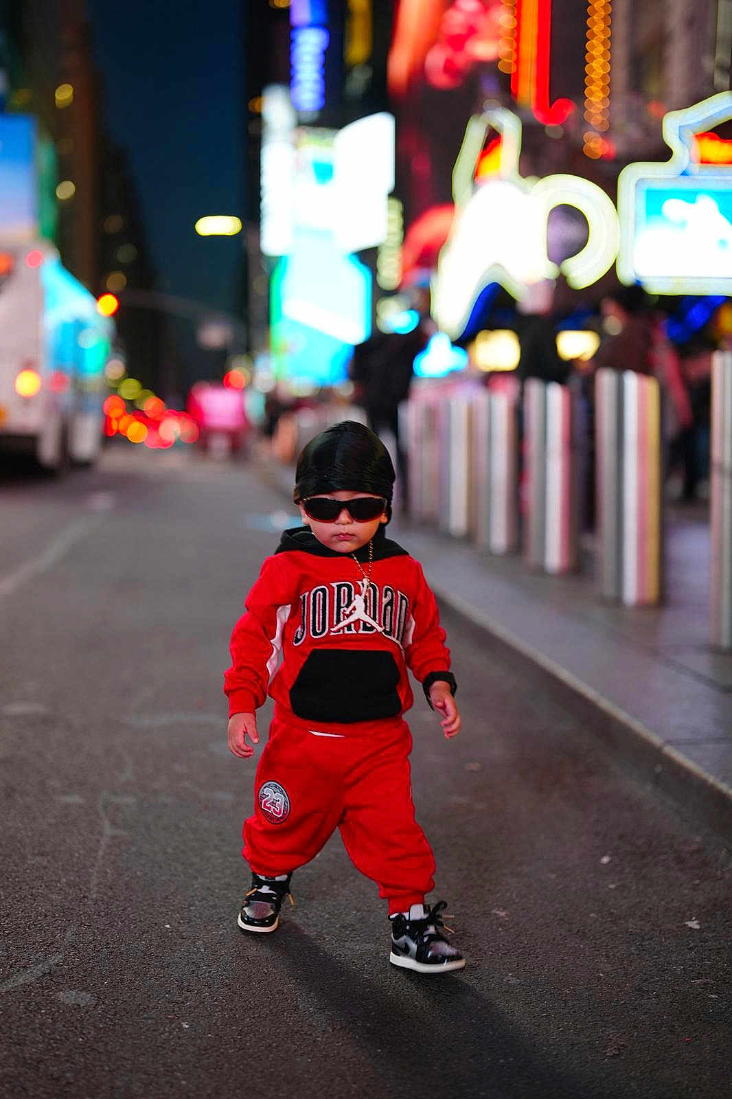 Arian Ovalle joined the competition — help win amazing prizes! child, toddler, street, night, urban, fashion, red_clothing, jordan, sunglasses, durag, sneakers, walking, sidewalk, lights, neon, city, casual, cool, portrait, outdoor
