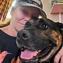 David is registered to the contest to win money with this photo: animal, bottle, cap, casual, closeup, clothing, curtains, dog, face, furniture, hand, happy, human, indoor, pet, shelf, smiling, snuggling, tongue_out, woman