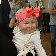 Lena joined the competition — help win amazing prizes! baby, child, infant, smiling, pink_bow, headband, white_outfit, stuffed_animal, cow_toy, portrait, indoor, party, people, adults, family, seated, happy, cheeks, wooden_floor, photography