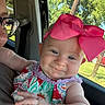 Lena joined the competition — help win amazing prizes! baby, child, infant, portrait, car, car_interior, car_seat, pink_bow, bow, dress, colorful_clothing, smiling, face, eyes, outdoor, trees, sunlight, window, adult, road_trip