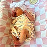 newborn, baby, sleeping, infant, portrait, bow, headband, onesie, blanket, pink, checkered, hospital, wristband, curled, feet, hands, peaceful, indoors, bedding, birth_announcement