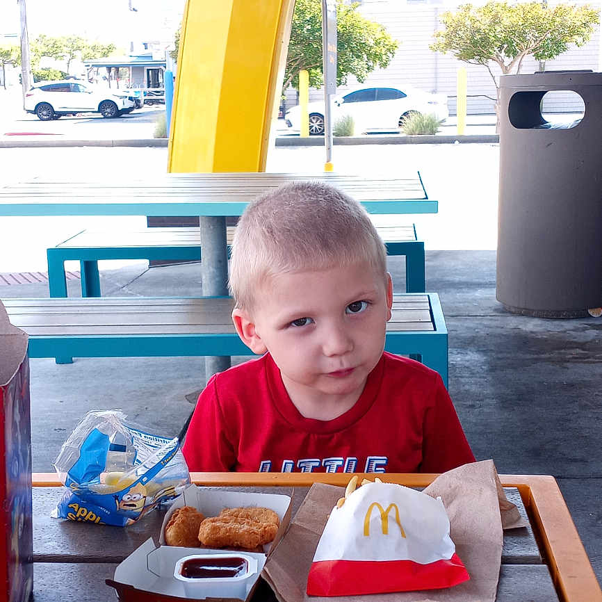 Zane is registered to the contest to win money with this photo: boy, car, child, cream, dessert, diningtable, face, food, furniture, head, icecream, indoors, lunch, male, meal, person, photography, portrait, restaurant, table
