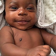 Isaiah joined the competition — help win amazing prizes! baby, infant, smile, face, skin, arm, hand, towel, texture, cozy, cute, portrait, closeup, child, newborn, happy, expression, wrapped, soft, young
