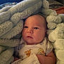 Micah is registered to the contest to win money with this photo: baby, blanket, infant, clothing, cute, face, newborn, person, portrait, soft, warm, wrapped, mitten, onesie, animal_print, cozy, indoor, child, young, comfort