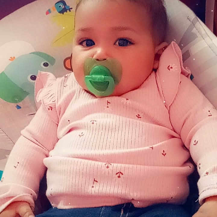 Nova is registered to the contest to win money with this photo: baby, biting, clothing, coat, cushion, face, furniture, happy, head, homedecor, jacket, jeans, pants, person, photography, portrait, sitting, sleeve, smile, t_shirt