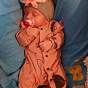 Leyah participe au concours pour gagner de l'argent avec cette photo : baby, sleeping, onesie, headband, flower, pacifier, blanket, toy, giraffe, footwear, slippers, cute, pink, blue, yellow, infant, child, soft, peaceful, indoor
