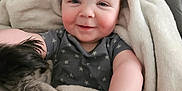 Ryder joined the competition — help win amazing prizes! baby, smile, blanket, dog, pet, cozy, indoor, happy, child, toddler, furniture, carpet, clothing, person, cute, snuggle, fur, home, comfort, portrait