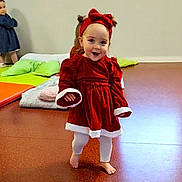 Loëlya participe au concours pour gagner de l'argent avec cette photo : another_child, barefoot, child, cushions, floor, happy, headband, headwear, indoor, leggings, long_sleeves, pale_wall, playroom, red_dress, smiling, toddler, tree_outside, walking, window, young_child