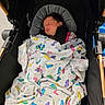 newborn, baby, blanket, butterfly_pattern, stroller, sleeping, child, infant, cozy, portrait, black, wooden, fabric, cute, peaceful, indoors, resting, soft, wrapped, person