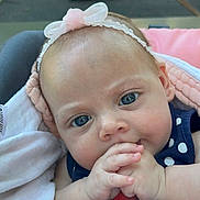 Serenity is registered to the contest to win money with this photo: baby, infant, face, blue_eyes, headband, pink_bow, hand, clothing, polka_dot, blanket, cute, portrait, close_up, child, newborn, soft_light, skin, expression, indoors, person