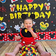 Jesus joined the competition — help win amazing prizes! baby, child, birthday, birthday_cake, mickey_mouse, disney_theme, costume, smiling, happy, sitting, portrait, party, cake, colorful, indoor, backdrop, wooden_floor, celebration, frosting, baby_food