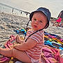 baby, beach, child, curious, hat, outdoor, people, play, portrait, sand, sea, sitting, striped_shirt, summer, sun_hat, sunlight, toddler, towel, vacation, water