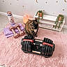 cat, tortoiseshell_cat, pink_rug, adjustable_dumbbell, rose_gold_dumbbells, water_bottle, workout_gear, salt_lamp, plants, decor, stars, moons, shelf, tile_floor, indoor, cozy, fitness, motivational, cute, pet