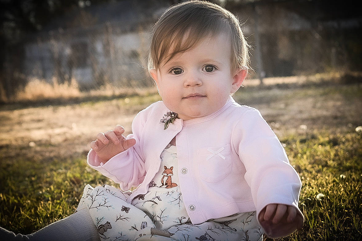 Adelynn is registered to the contest to win money with this photo: baby, cheek, child, eye, face, grass, happy, head, people, people_in_nature, person, photograph, photography, pink, portrait, portrait_photography, sitting, skin, smile, toddler