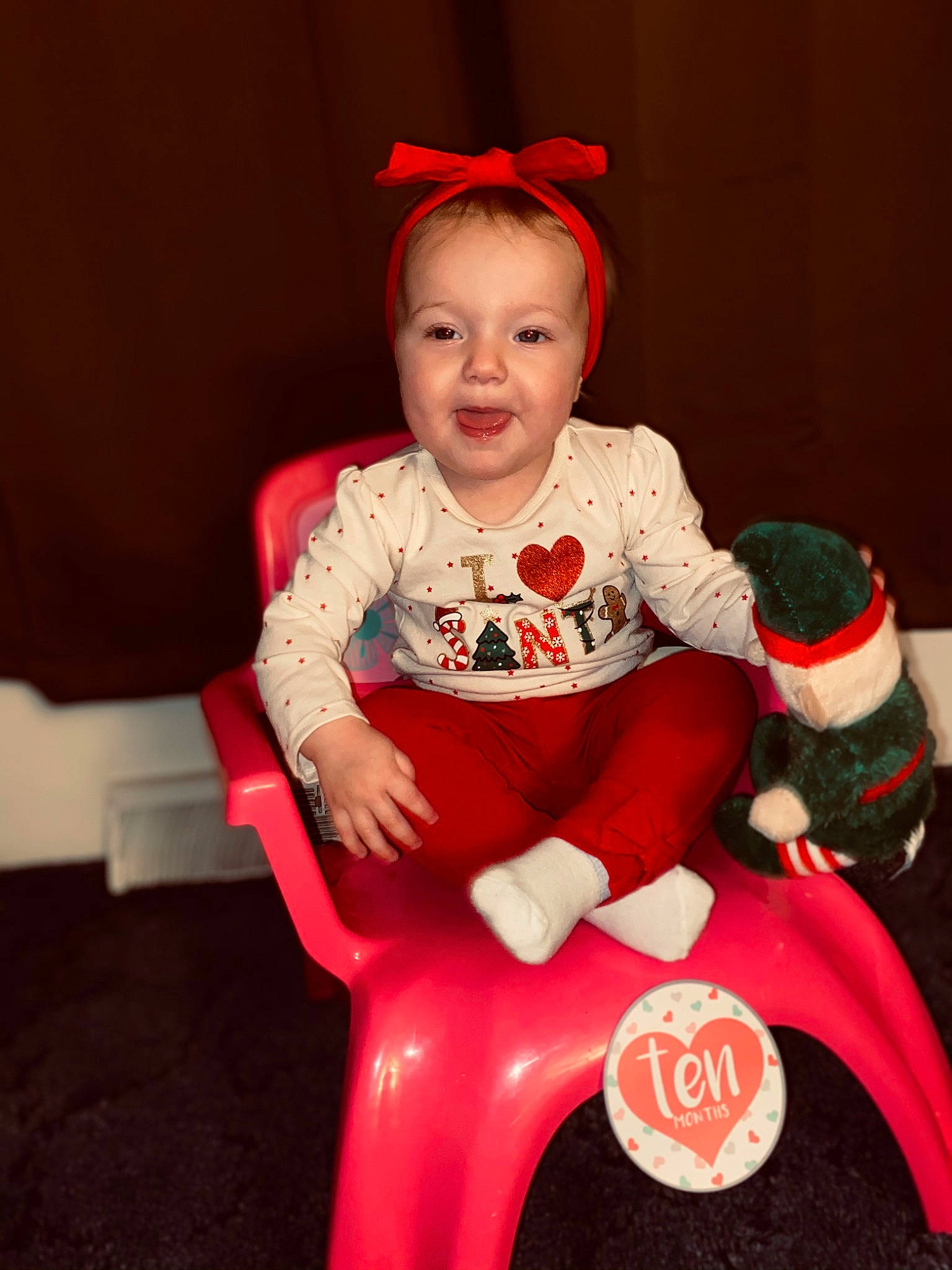 Brayleigh joined the competition — help win amazing prizes! baby, baby_toddler_clothing, baby_toys, carmine, christmas, costume, costume_accessory, costume_hat, ear, fictional_character, hair_accessory, headband, holiday, mouth, person, red, riding_toy, sitting, stuffed_toy, toddler