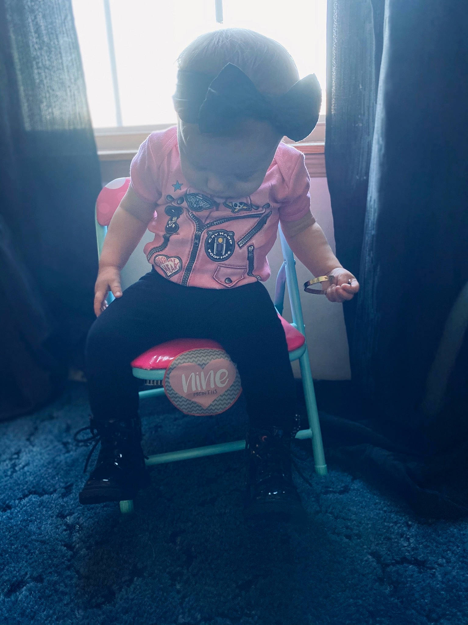 Brayleigh is registered to the contest to win money with this photo: baby, baby_products, baby_toddler_clothing, baggage, ball, curtain, household_supply, person, toy, vacuum_cleaner, window_covering, window_treatment