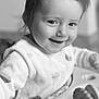 toddler, child, baby, smiling, face, hair, pony_tail, activity_center, toy, indoor, monochrome, black_and_white, cute, happy, infant, clothing, person, closeup, playful, young